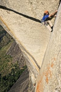 Bullet stone in the thin dihedral that leads off the slabs. This 5.12d crack ends abruptly halfway up the prow, but, amazingly, a sea of knobs leads all the way to the summit. Photo: Klaus Fengler.