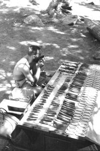 Royal Robbins sorts hardware for the second ascent of The Nose, El Capitan, by Robbins, Chuck Pratt, Joe Fitschen and Tom Frost. Spread out on the Camp 4 table, most of these pitons were handmade by Yvon Chouinard. Photo by Tom Frost.